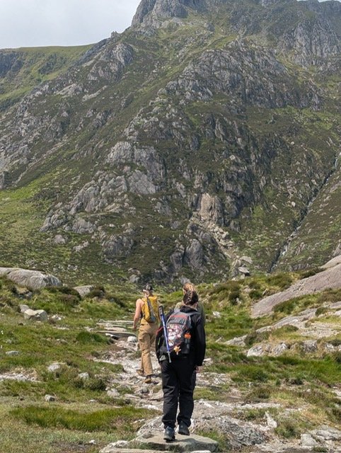 Staff walking up a mountain trail