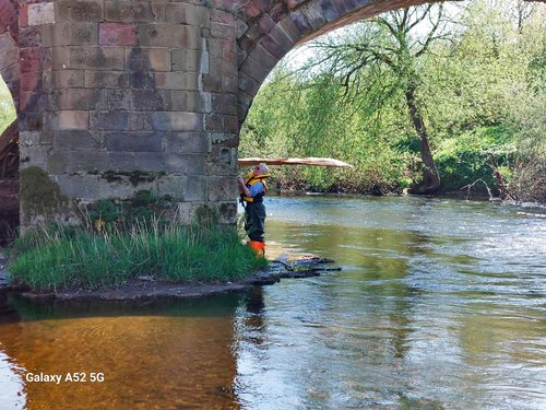 Conservation Officer under a bridge